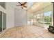 Bright sunroom with tile flooring, ceiling fan, wood burning stove and lots of natural light at 6259 Se 120Th Pl, Belleview, FL 34420