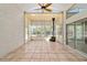 Bright sunroom with tile flooring, ceiling fan, wood burning stove and lots of natural light at 6259 Se 120Th Pl, Belleview, FL 34420