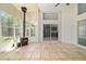 Bright sunroom with tile flooring, ceiling fan, wood burning stove and lots of natural light at 6259 Se 120Th Pl, Belleview, FL 34420