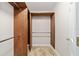 Walk-in Closet with custom wood shelving and tile flooring at 6259 Se 120Th Pl, Belleview, FL 34420
