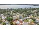 Aerial view of a lakeside community, outlined property, and mature trees providing shade and beauty at 670 Oleander St, Mount Dora, FL 32757