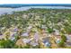 Stunning aerial view of a lakeside community, showcasing mature trees, spacious yards, and beautiful sunny skies at 670 Oleander St, Mount Dora, FL 32757