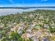 Picturesque aerial view of a lakeside community with lush greenery and houses with swimming pools at 670 Oleander St, Mount Dora, FL 32757