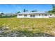 Backyard view of home exterior, showcasing yard with great potential at 670 Oleander St, Mount Dora, FL 32757