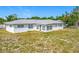 Expansive backyard featuring a white house with a screened-in porch, offering ample outdoor space at 670 Oleander St, Mount Dora, FL 32757