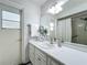 Bathroom with a large mirror, a white countertop, and a shower with a white curtain at 670 Oleander St, Mount Dora, FL 32757