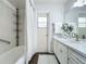 Bathroom features a tub/shower combo, and a vanity with sink at 670 Oleander St, Mount Dora, FL 32757