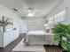 Bright bedroom with laminate flooring, light walls and a leafy, green plant at 670 Oleander St, Mount Dora, FL 32757