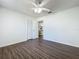 Bright bedroom featuring dark wood-look floors and a ceiling fan at 670 Oleander St, Mount Dora, FL 32757