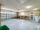 Spacious garage with large door, workbench, and laundry hookups at 670 Oleander St, Mount Dora, FL 32757
