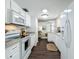 This kitchen boasts modern white appliances, solid surface countertops, and updated cabinetry at 670 Oleander St, Mount Dora, FL 32757