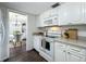 Lovely eat-in kitchen with bright window, stainless appliances and white cabinetry at 670 Oleander St, Mount Dora, FL 32757