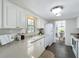 Bright open kitchen shows solid surface countertops, white appliances and lots of natural light at 670 Oleander St, Mount Dora, FL 32757