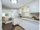 Bright eat-in kitchen offers ample counter space, white appliances, and wood-look flooring at 670 Oleander St, Mount Dora, FL 32757