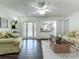 Open-concept living room with access to lanai and kitchen, featuring modern decor at 670 Oleander St, Mount Dora, FL 32757