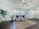 Comfortable living room with large window for natural light, modern furniture, decor and dark wood floors at 670 Oleander St, Mount Dora, FL 32757