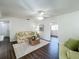 Inviting living room featuring a floral sofa, area rug, and stylish furnishings at 670 Oleander St, Mount Dora, FL 32757