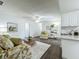 Open concept living room with wood-look flooring, natural light and neutral paint at 670 Oleander St, Mount Dora, FL 32757