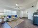Well-lit living room with stylish decor, wood floors, and a comfortable couch adjacent to the front door at 670 Oleander St, Mount Dora, FL 32757
