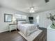 Comfortable main bedroom with a ceiling fan, ensuite bathroom, and ample closet space at 670 Oleander St, Mount Dora, FL 32757