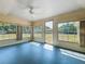 Inviting sunroom with fan and windows offering tranquil views of the backyard at 670 Oleander St, Mount Dora, FL 32757