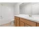 Well-lit bathroom with a bathtub-shower combo and wood cabinetry at 674 Anna Ridge Rd, Minneola, FL 34715