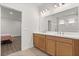 Bathroom featuring a double sink vanity and view into a bedroom at 674 Anna Ridge Rd, Minneola, FL 34715