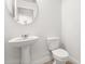Clean half-bathroom featuring a pedestal sink and classic white toilet at 674 Anna Ridge Rd, Minneola, FL 34715