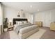 Beautiful bedroom with a neutral color palette, a soft rug, and stylish furniture at 674 Anna Ridge Rd, Minneola, FL 34715