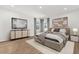Modern bedroom with a plush bed, stylish decor, and ample natural light at 674 Anna Ridge Rd, Minneola, FL 34715