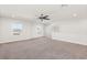 Spacious bonus room with two windows for natural light and custom shelving for extra storage at 674 Anna Ridge Rd, Minneola, FL 34715