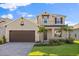 Charming two-story home featuring stone accents, a paved driveway, and meticulously landscaped front yard at 674 Anna Ridge Rd, Minneola, FL 34715
