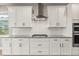 Close up view of the kitchen featuring white cabinetry, stainless steel appliances, and granite countertops at 674 Anna Ridge Rd, Minneola, FL 34715