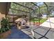 Beautiful screened-in backyard featuring a playhouse and a relaxing entertainment space perfect for outdoor fun at 6750 Sunnyside Dr, Leesburg, FL 34748