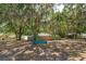 Spacious backyard area shaded by mature trees with Spanish moss and a wooden fence at 6750 Sunnyside Dr, Leesburg, FL 34748