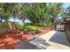 Lush backyard featuring well-manicured landscaping, a patio area, and a screen enclosure for year-round enjoyment at 6750 Sunnyside Dr, Leesburg, FL 34748