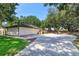 Backyard view of lush property with a detached storage shed, patio area, and well-maintained lawn at 6750 Sunnyside Dr, Leesburg, FL 34748