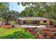 Expansive backyard showcasing lush landscaping, a patio area, and a screened-in enclosure for outdoor enjoyment at 6750 Sunnyside Dr, Leesburg, FL 34748