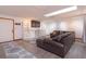 Finished basement features a seating area with a leather couch, shelving, and neutral decor at 6750 Sunnyside Dr, Leesburg, FL 34748