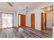 Foyer with hardwood floors and modern lighting offers a welcoming and stylish entrance to the home at 6750 Sunnyside Dr, Leesburg, FL 34748