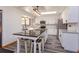 Updated kitchen featuring white cabinets, stainless appliances, a center island with seating and a skylight at 6750 Sunnyside Dr, Leesburg, FL 34748