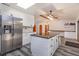 Updated kitchen with white cabinets, a center island with seating, and stainless steel refrigerator at 6750 Sunnyside Dr, Leesburg, FL 34748