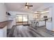Bright kitchen with white cabinets, an island with seating, and sliding door access to the patio at 6750 Sunnyside Dr, Leesburg, FL 34748