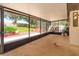 Enclosed back porch featuring a picturesque backyard view and access to an outdoor entertainment area at 6750 Sunnyside Dr, Leesburg, FL 34748