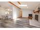 Open floor plan showcasing the living room with a stone fireplace and kitchen with a center island at 6750 Sunnyside Dr, Leesburg, FL 34748