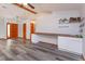 Open living space featuring a custom coffee bar, gray wood-look flooring, and a front entrance at 6750 Sunnyside Dr, Leesburg, FL 34748