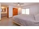 Sunlit primary bedroom with closet, ensuite bath, ceiling fan, and sliding doors providing convenient backyard access at 6750 Sunnyside Dr, Leesburg, FL 34748