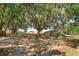 Expansive lot with mature trees offering shade and privacy, perfect for enjoying the outdoors at 6750 Sunnyside Dr, Leesburg, FL 34748
