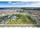 An aerial view of the community with houses, green space, amenities, and a lake in the background at 6816 Perch Hammock Loop, Groveland, FL 34736