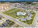 Aerial view showcases community layout with amenities, green spaces, and neighborhood homes at 6816 Perch Hammock Loop, Groveland, FL 34736
